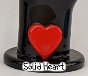 detail photo of red solid heart on black i love you hand